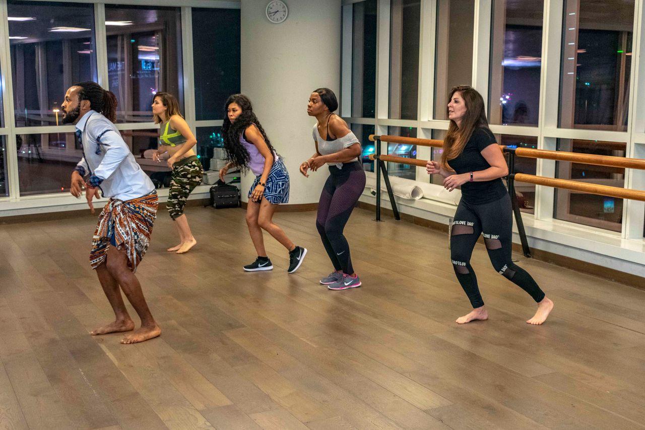 about-us Energetic dance class with diverse adults embracing active lifestyle indoors.